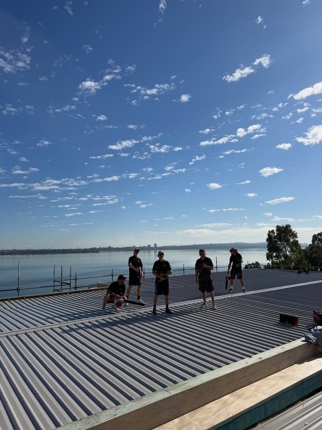 The McDonald Roofing crew on a finished COLORBOND® steel roof in Perth, enjoying the view