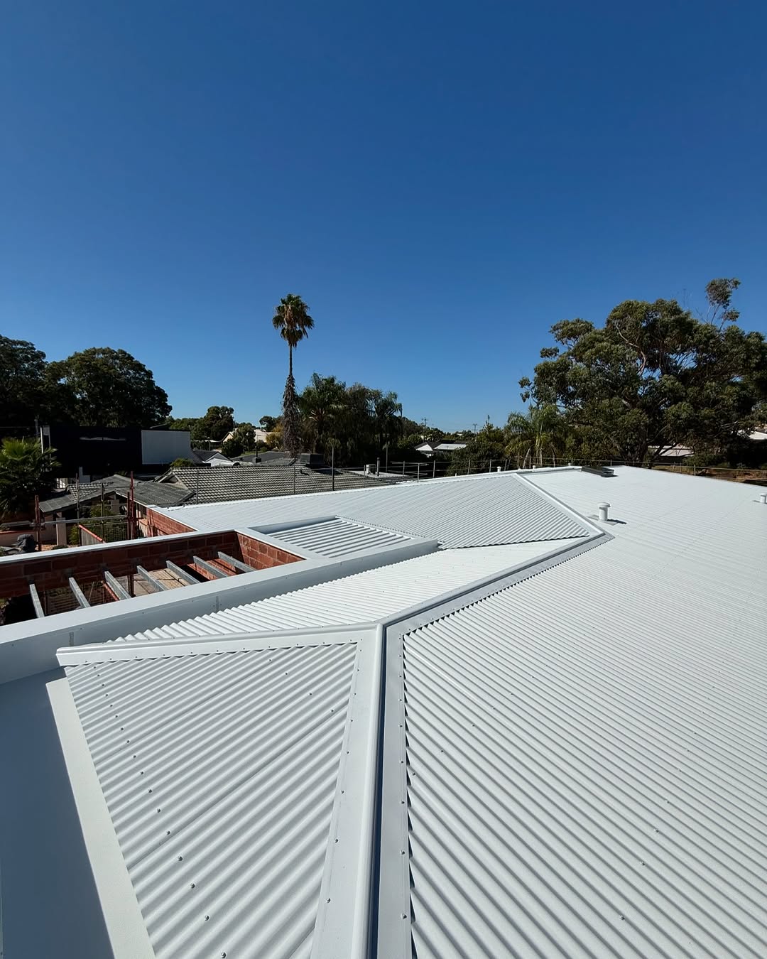 Completed metal roof with clean lines and a tight finish on a custom Perth home
